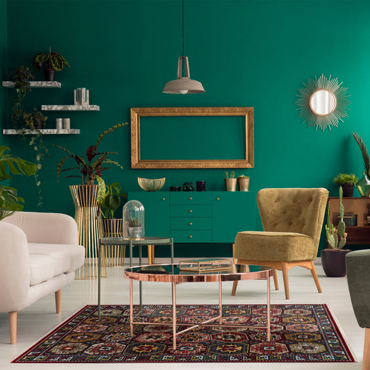 Modern bohemian green living room with brass and beige decor, plants and Rakkas Boho Ruh